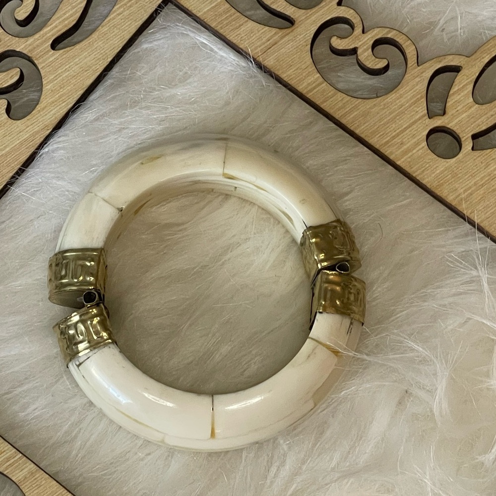 Indian Style Brass & Wood Bangle with White tones.  
3" x 1 1/4” wide.